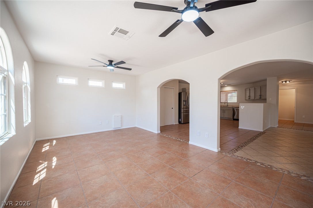 6133 Crystal Talon Street, Las Vegas, NV 89130 Arched doorways connect this spacious living area to the adjacent kitchen and dining spaces.