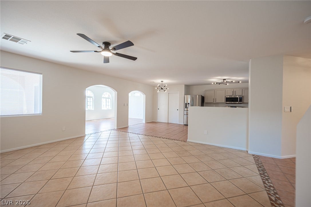 6133 Crystal Talon Street, Las Vegas, NV 89130 Arched doorways and tile flooring define this spacious open living area.
