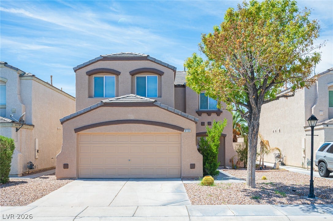 6133 Crystal Talon Street, Las Vegas, NV 89130 Arched window surrounds and a barrel-tile roof accent this modern two-story home with a front garage.