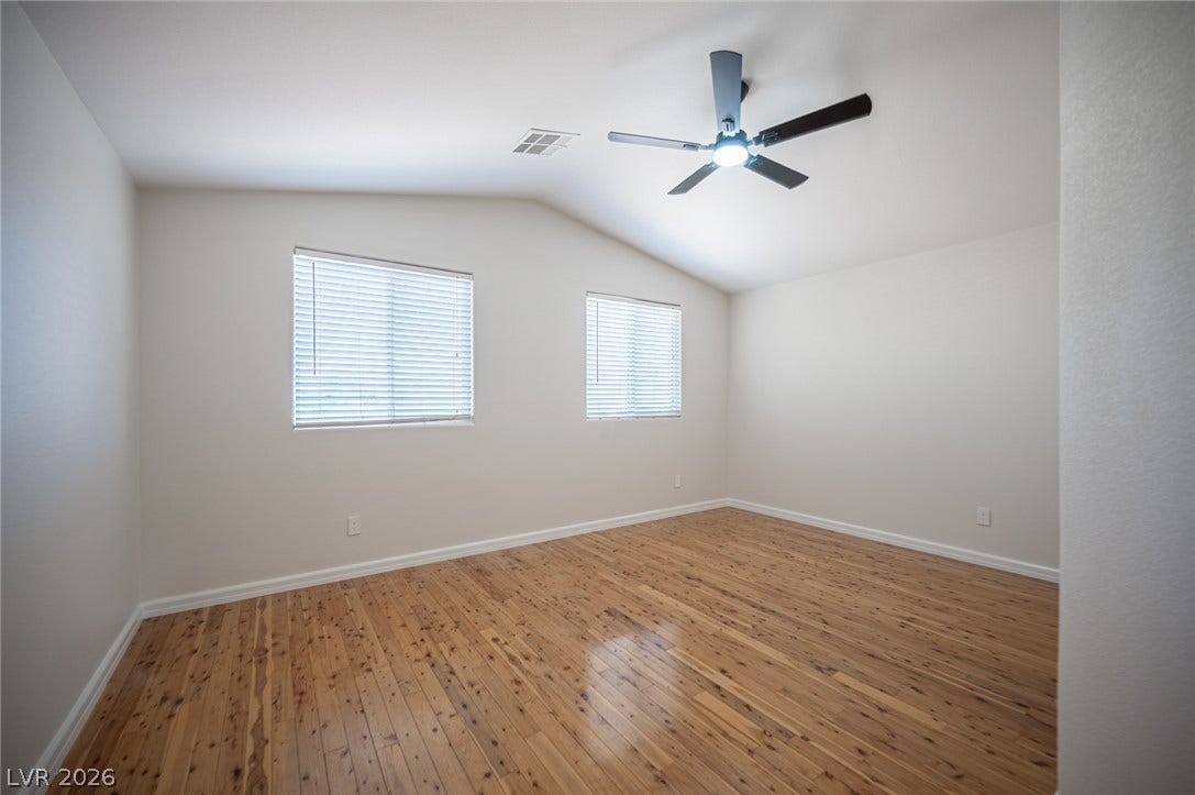 6133 Crystal Talon Street, Las Vegas, NV 89130 Polished hardwood flooring and vaulted ceilings define this versatile bedroom # 4.