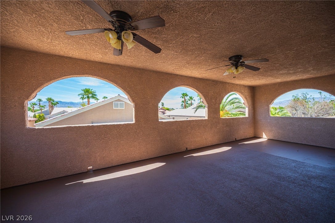 6133 Crystal Talon Street, Las Vegas, NV 89130 Arched open-air windows frame panoramic views of the surrounding neighborhood and desert mountains.