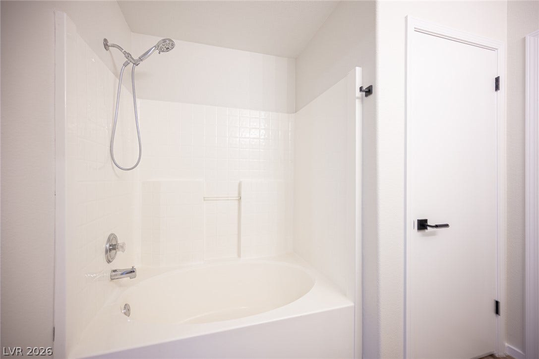 6133 Crystal Talon Street, Las Vegas, NV 89130 An alcove soaking tub and shower combination anchors this clean, minimalist bathroom design.