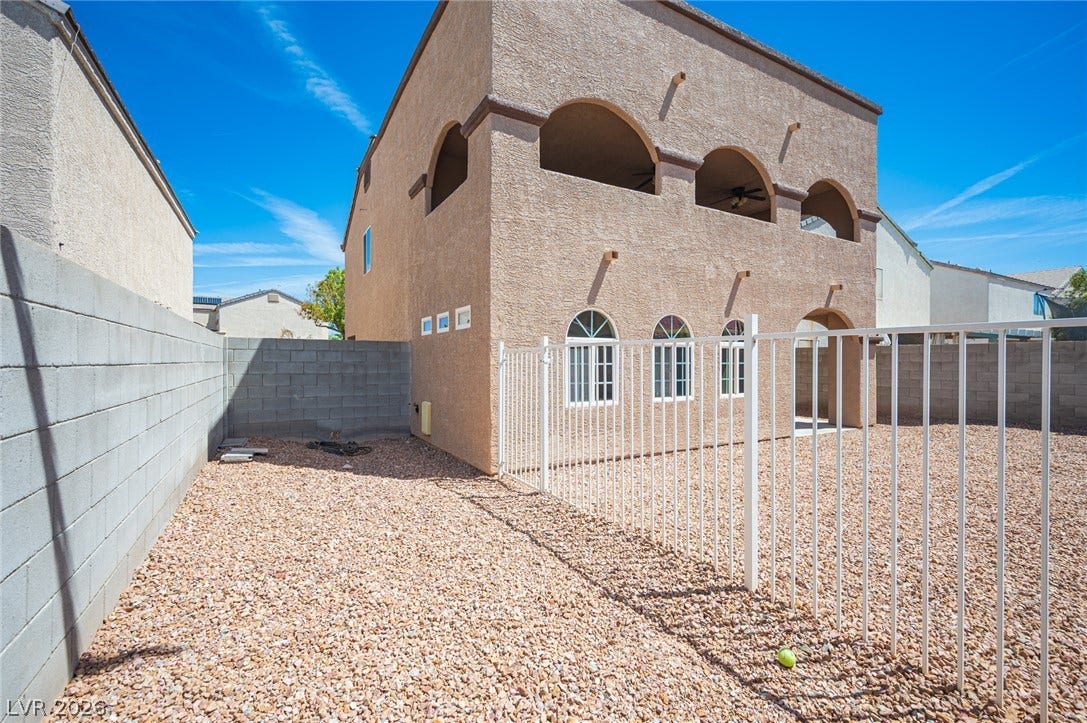 6133 Crystal Talon Street, Las Vegas, NV 89130 Arched windows and a spacious upper balcony define the exterior of this southwestern-style home.