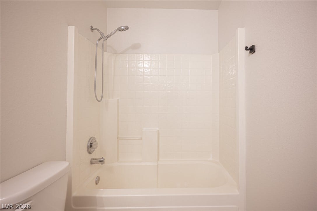 6133 Crystal Talon Street, Las Vegas, NV 89130 Clean tiling and a practical tub shower combination define this functional bathing space.
