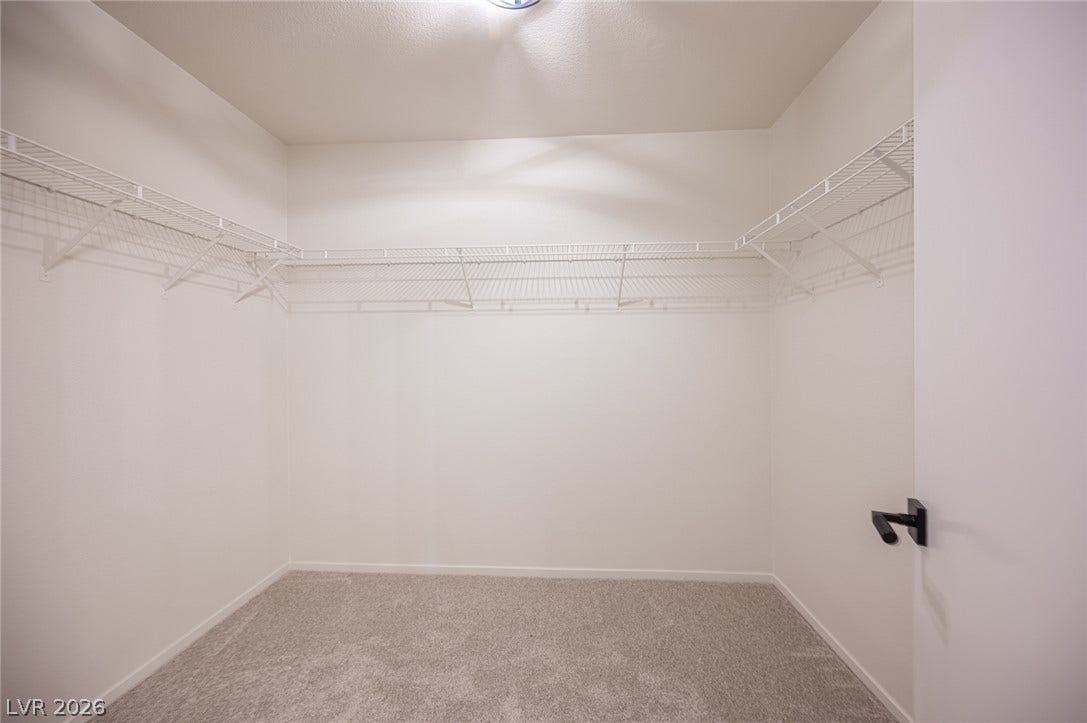6133 Crystal Talon Street, Las Vegas, NV 89130 Ample wire shelving lines this functional walk-in closet space complete with soft carpeting.