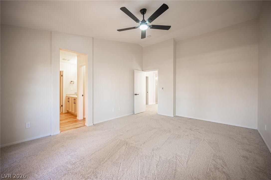 6133 Crystal Talon Street, Las Vegas, NV 89130 High vaulted ceilings and plush carpeting define this spacious primary bedroom suite.