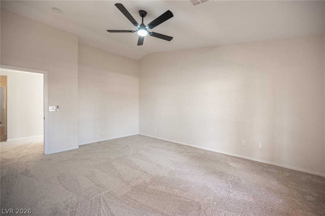 6133 Crystal Talon Street, Las Vegas, NV 89130 Vaulted ceilings and plush carpeting define this airy primary bedroom space.