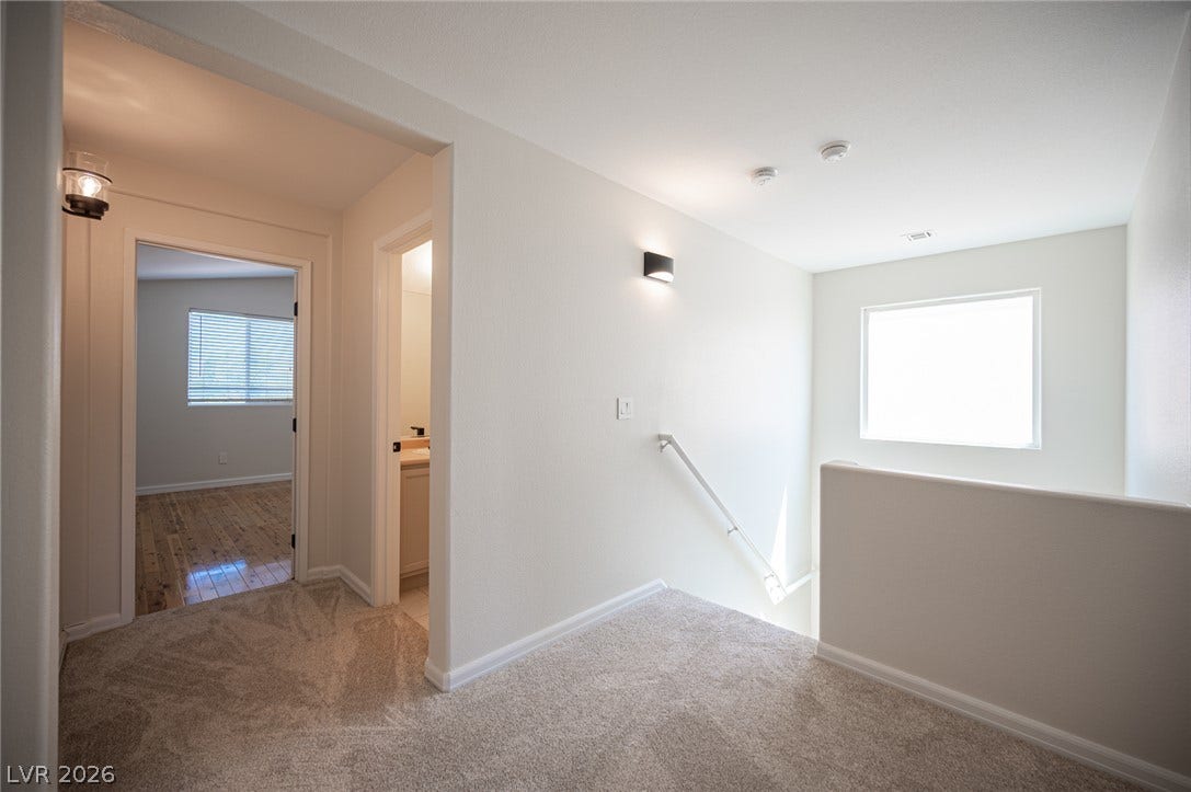 6133 Crystal Talon Street, Las Vegas, NV 89130 An open upper landing features clean drywall finishes, soft carpeting, and access to nearby rooms.