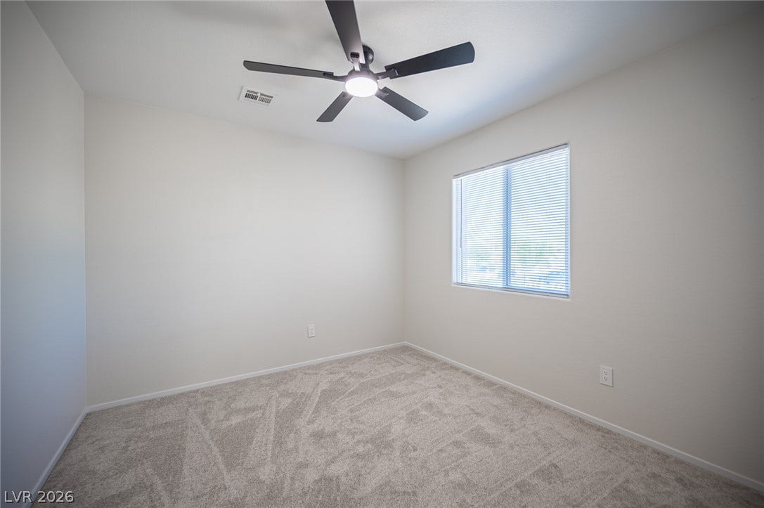 6133 Crystal Talon Street, Las Vegas, NV 89130 Soft plush carpeting paired with clean neutral walls creates a tranquil and versatile bedroom #2.
