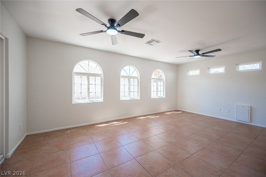 6133 Crystal Talon Street, Las Vegas, NV 89130 Arched windows and clean tile flooring define this open living area.