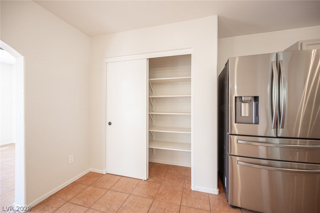 6133 Crystal Talon Street, Las Vegas, NV 89130 Tiled flooring and built-in shelving define this functional kitchen corner.