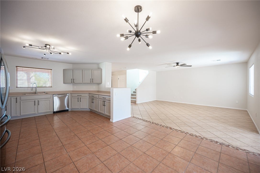 6133 Crystal Talon Street, Las Vegas, NV 89130 An open floor plan connects the kitchen and living areas over tiled flooring.