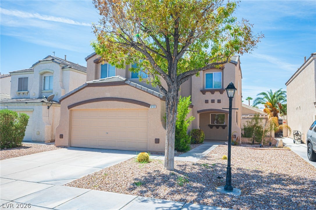 6133 Crystal Talon Street, Las Vegas, NV 89130 Arched rooflines and stucco siding define the front exterior of this two-level home.
