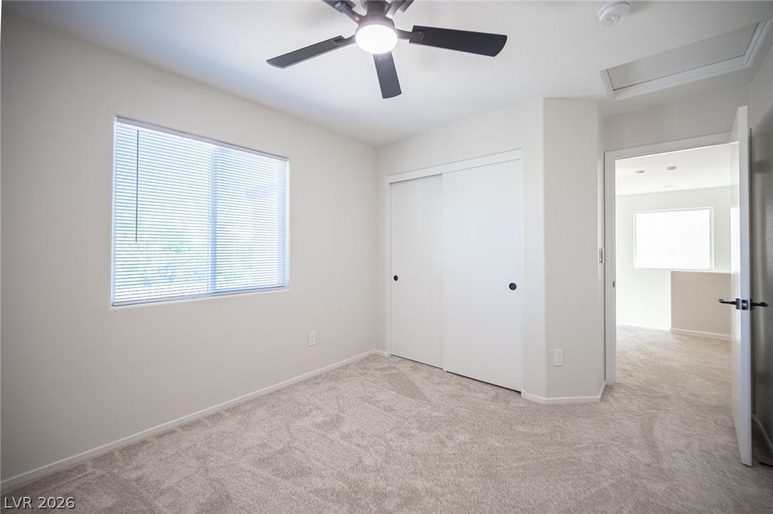 6133 Crystal Talon Street, Las Vegas, NV 89130 Soft plush carpeting pairs with sliding closet doors in this serene secondary bedroom #2.