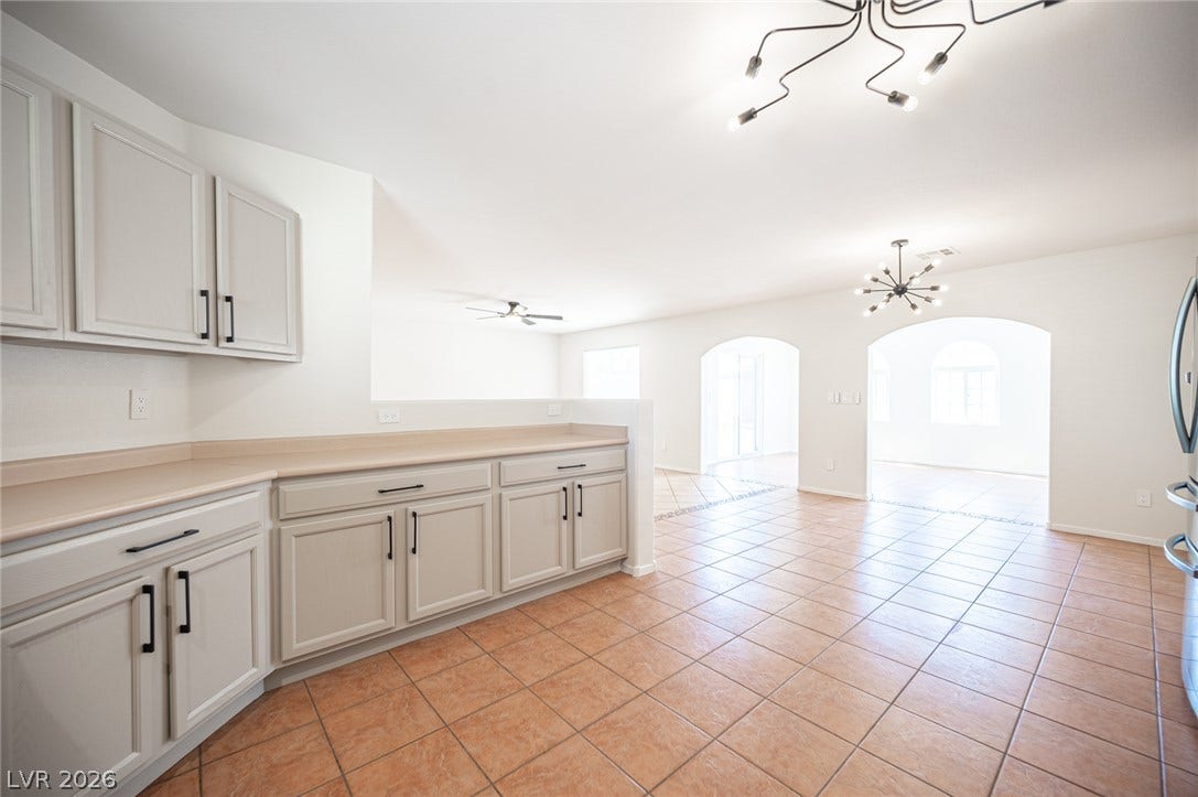 6133 Crystal Talon Street, Las Vegas, NV 89130 Arched doorways and tile flooring create a seamless transition between the kitchen and living spaces.