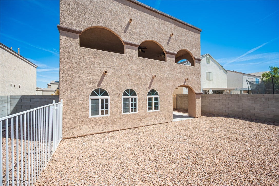 6133 Crystal Talon Street, Las Vegas, NV 89130 Distinctive arched window designs and stucco finishes frame this low-maintenance gravel yard.