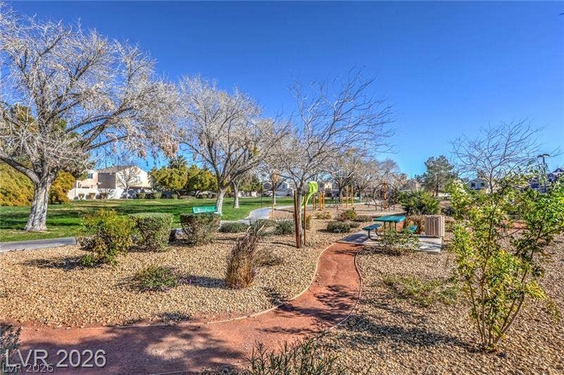 6133 Crystal Talon Street, Las Vegas, NV 89130 Winding pathways connect shaded seating areas and play structures under clear blue skies.