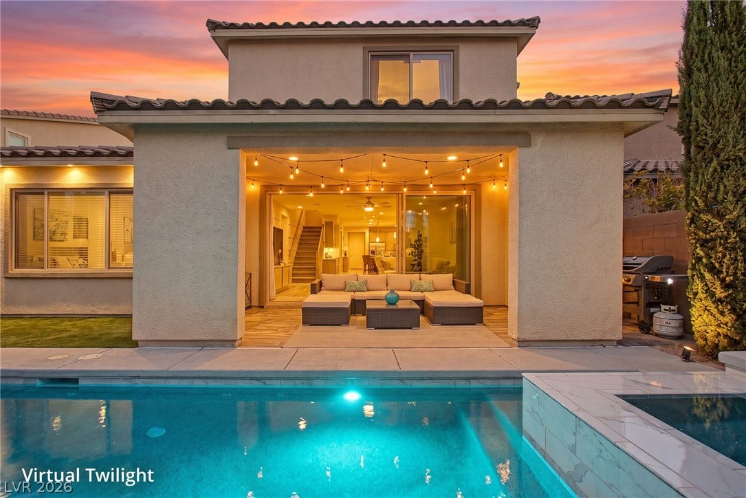 Mediterranean-inspired styling highlights this backyard oasis featuring a pool and integrated spa.