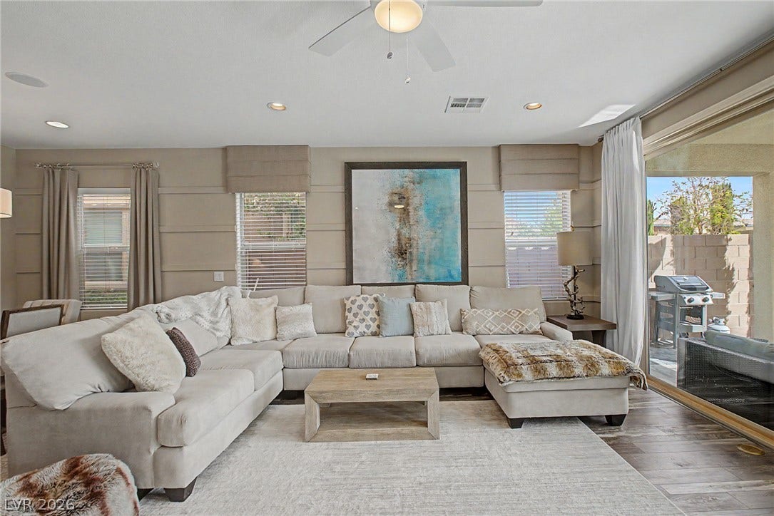 Sliding glass doors connect the comfortable living area directly to the private backyard patio.