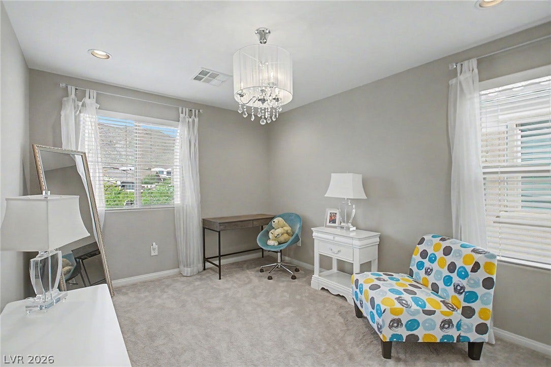 Plush carpeting and dual windows illuminate this versatile secondary bedroom space.