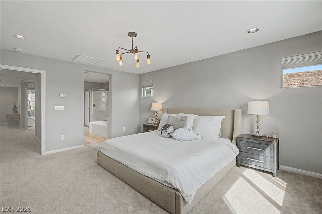 Recessed lighting and soft carpeting define this comfortable suite with an attached bath.