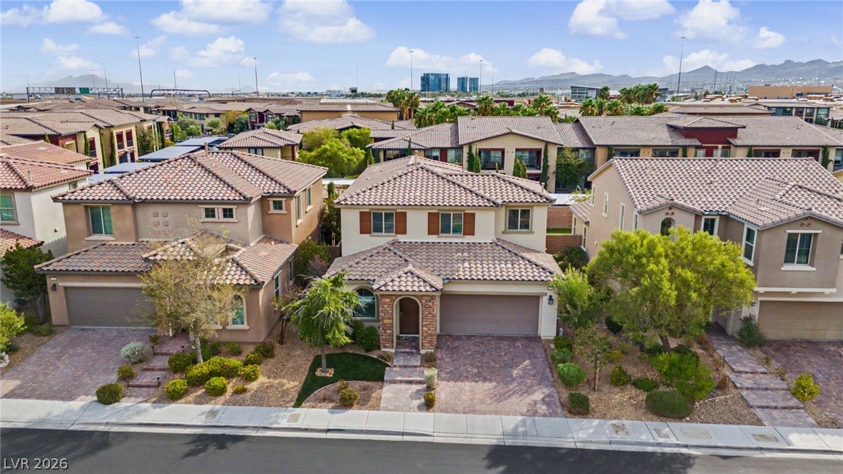 Spanish tile roofs and stone accents define this neat, suburban streetscape.