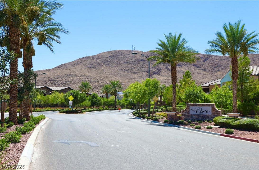 Towering mountain backdrops frame the paved streets of this gated desert community.
