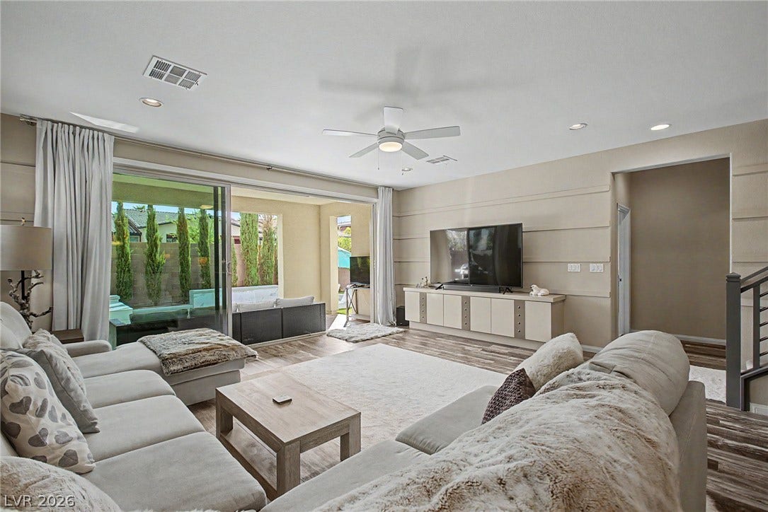 Sliding glass doors seamlessly connect this spacious interior living space to the outdoor patio.