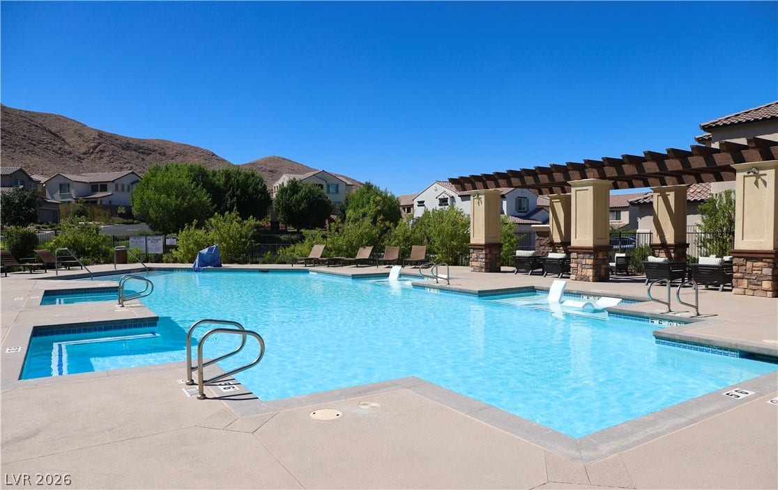 Sun-drenched patio and sparkling water highlight this inviting community pool area.