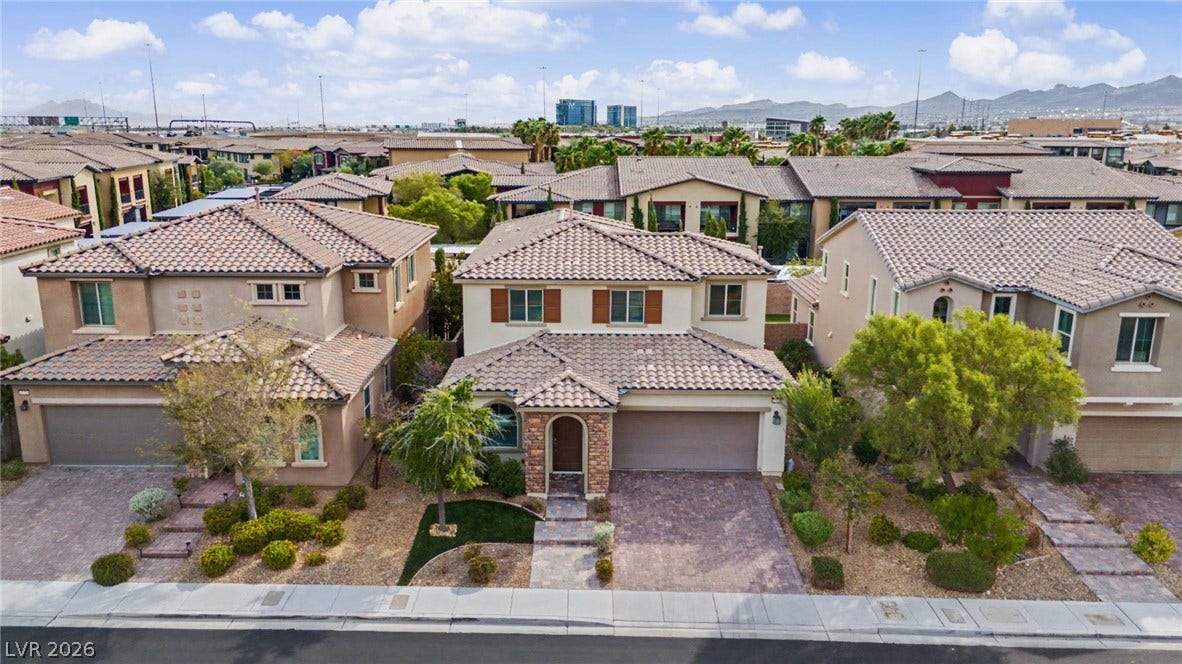 A classic tile roof and stone accents elevate this multi-level neighborhood home.