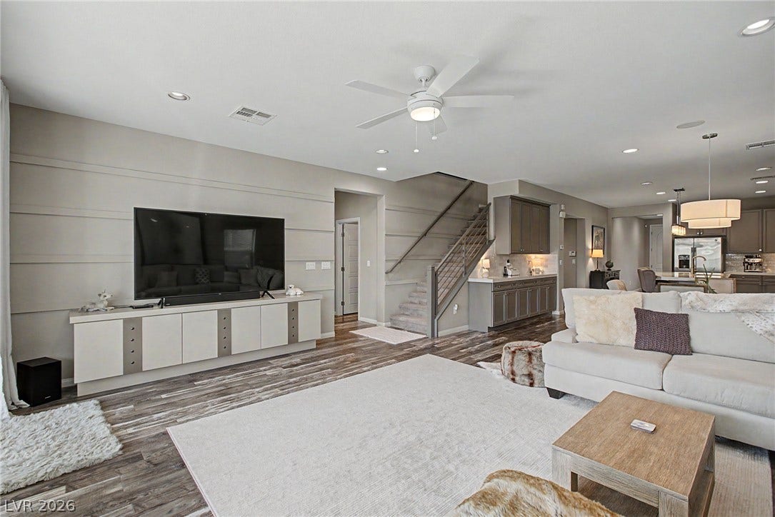 Clean lines and recessed lighting define this modern living space featuring a floating media console.