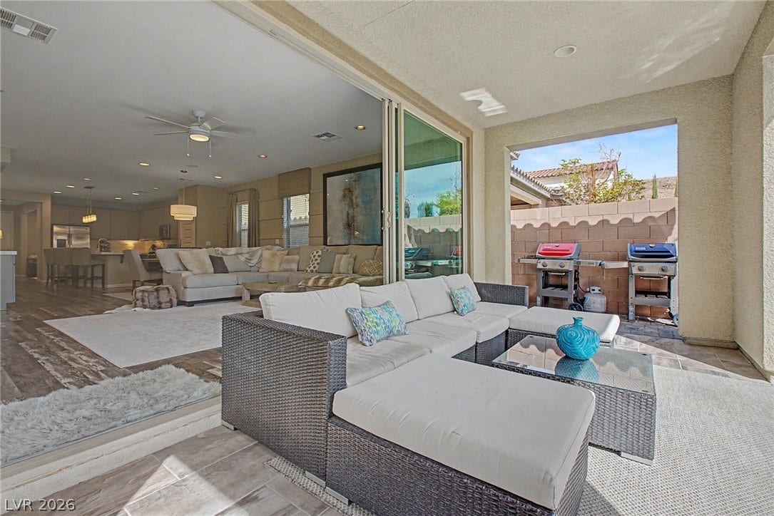 Sliding glass doors seamlessly connect the indoor living spaces to a covered outdoor patio.