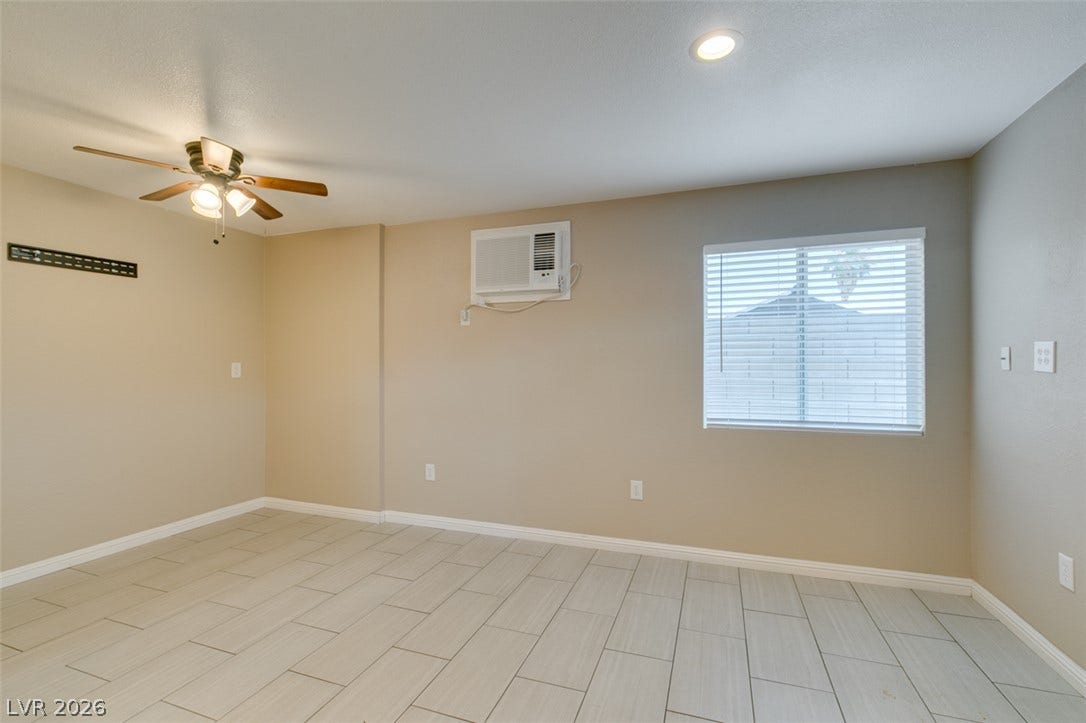 437 Waterwheel Falls Drive, Henderson, NV 89015 Guest house has own A/C unit. Tiled flooring and a bright window highlight this versatile living area.