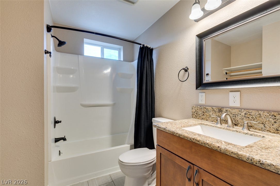 437 Waterwheel Falls Drive, Henderson, NV 89015 Guest house full bathroom. Natural stone counters and modern fixtures accent this clean, updated bathroom space.