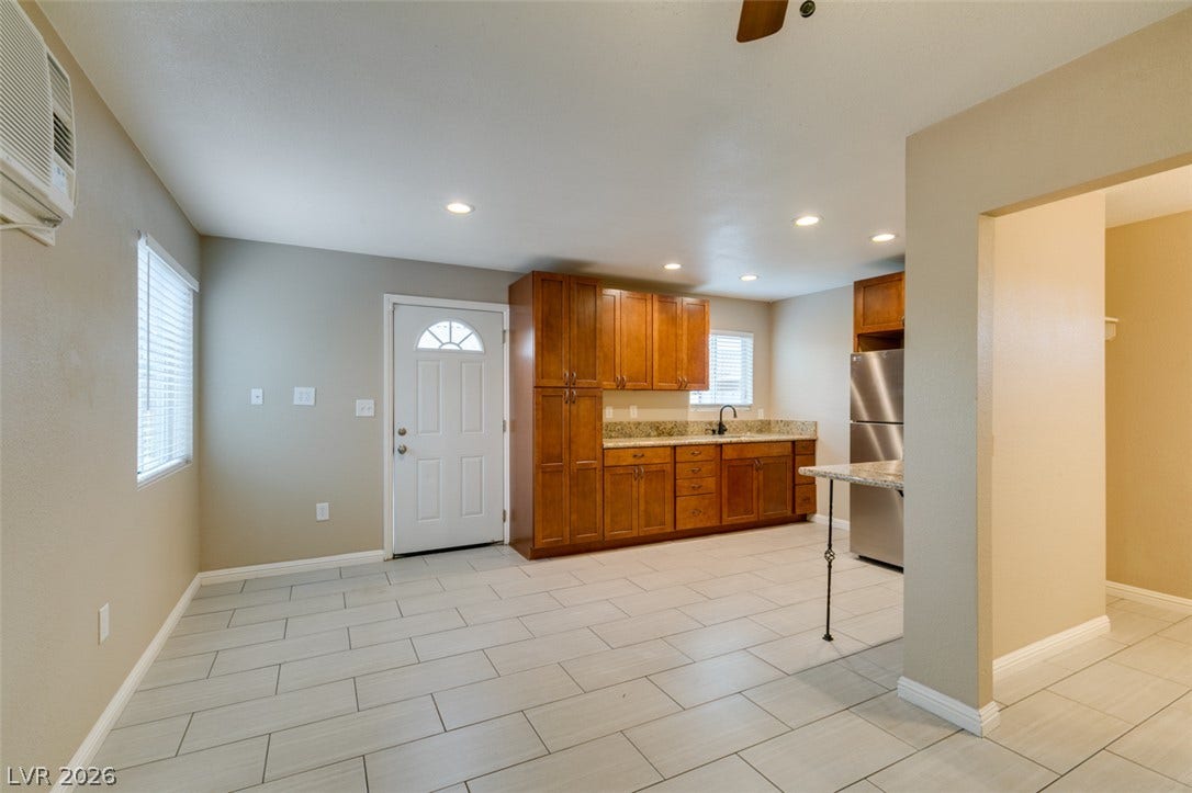 437 Waterwheel Falls Drive, Henderson, NV 89015 Guest house looking towards entrance. Crisp tile flooring flows through the open kitchen and dining area under recessed lighting.