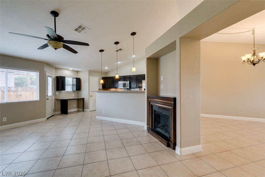 437 Waterwheel Falls Drive, Henderson, NV 89015 An open floor plan connects the tiled living space to the kitchen and dining areas.