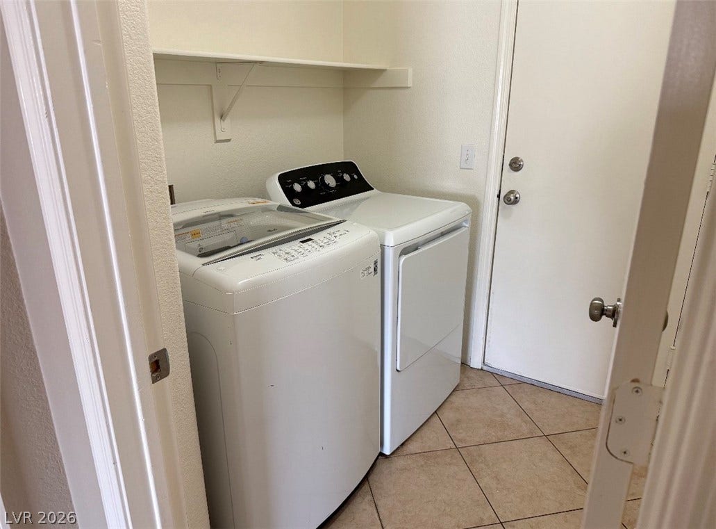 437 Waterwheel Falls Drive, Henderson, NV 89015 Primary house laundry room. Functional tile flooring and overhead shelving maximize utility in this dedicated laundry space.