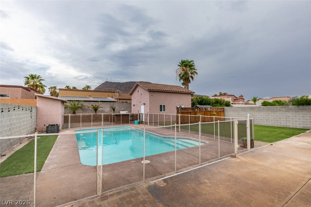 437 Waterwheel Falls Drive, Henderson, NV 89015 An inviting swimming pool serves as the centerpiece of this fenced backyard under desert skies.