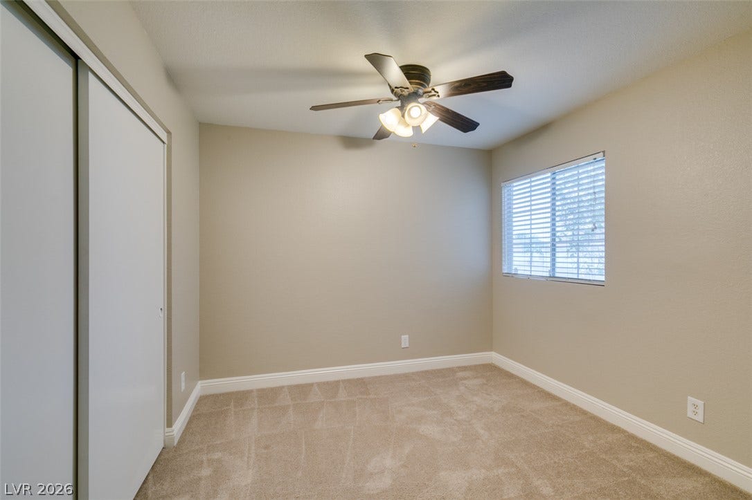 437 Waterwheel Falls Drive, Henderson, NV 89015 Soft carpeting pairs with neutral walls and classic baseboards in this inviting bedroom.