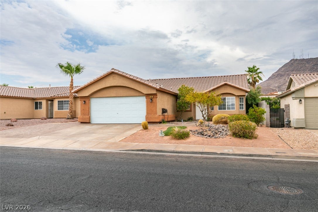 437 Waterwheel Falls Drive, Henderson, NV 89015 Desert landscaping and a tile roof define the exterior of this single-story home.