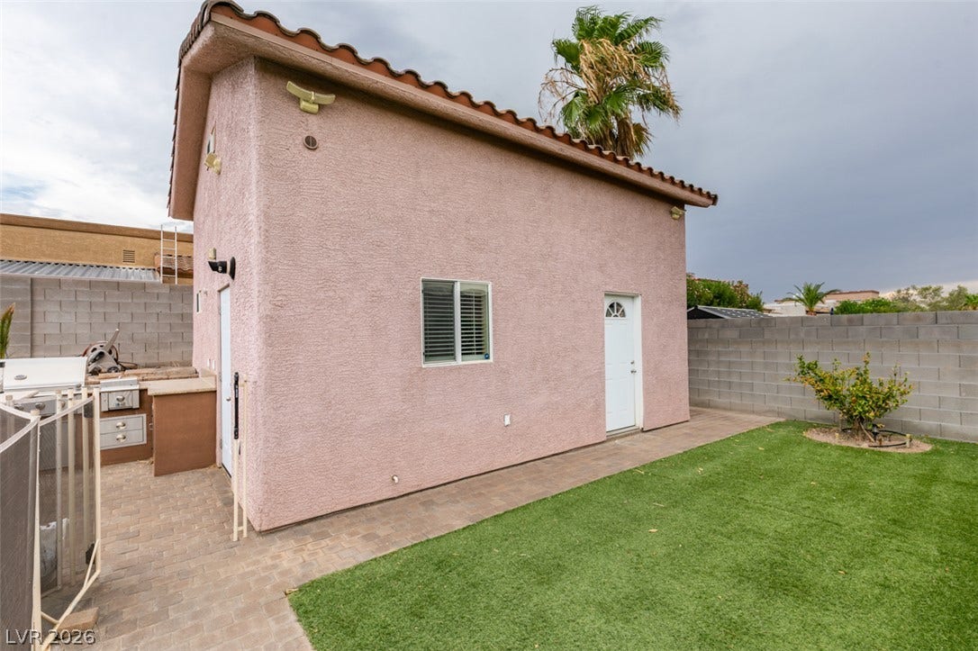 437 Waterwheel Falls Drive, Henderson, NV 89015 Guest house sits adjacent to a grassy lawn and paved patio space.
