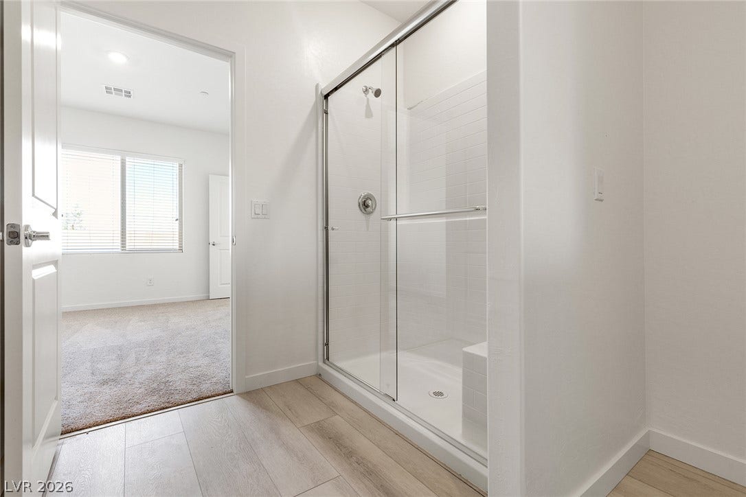 Clean lines and a glass-enclosed shower highlight this modern bathroom space.