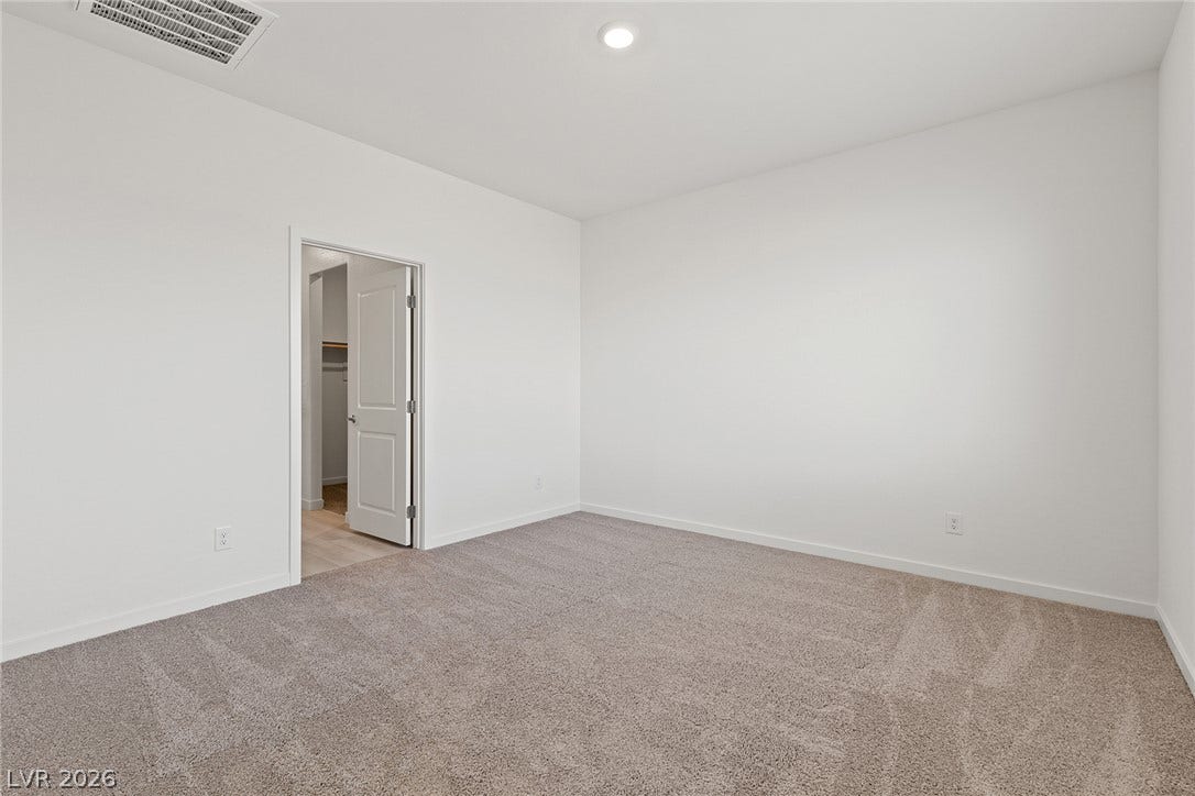 Recessed lighting and wall-to-wall carpeting define this versatile space.