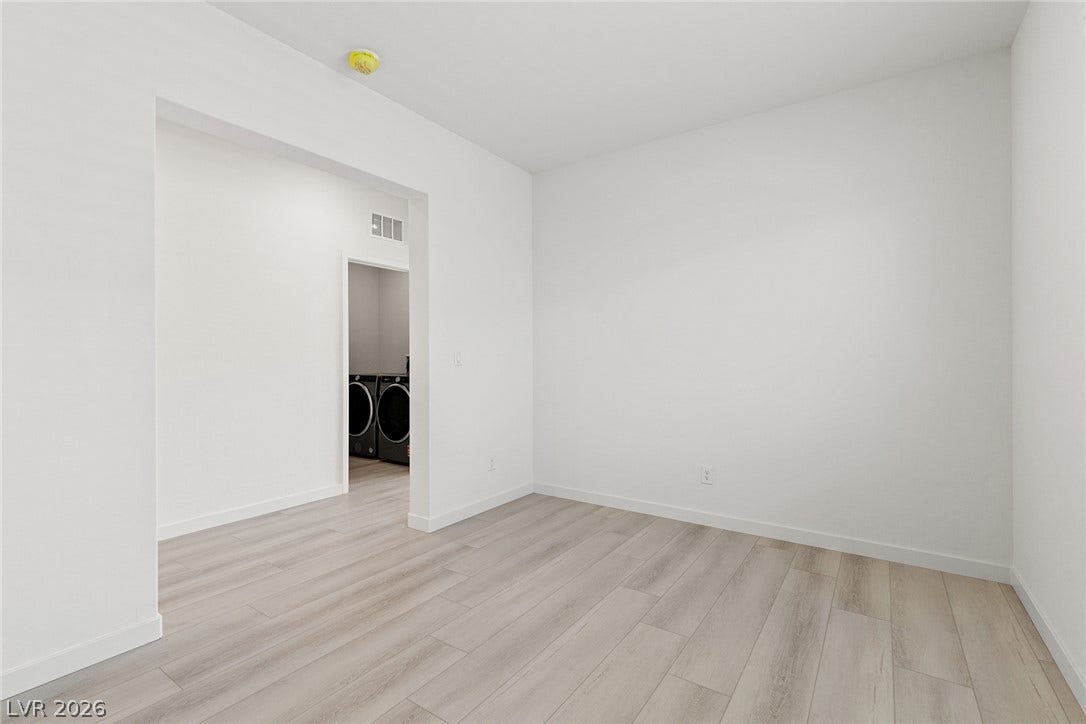 Smooth wood-look flooring and crisp white walls define this versatile interior flex space.