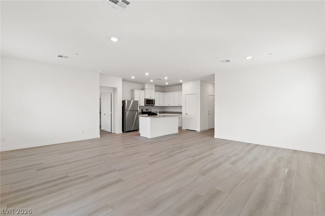 2754 Avril Point Street, Las Vegas, NV 89156 Smooth wood-look flooring and recessed lighting connect the living space to the kitchen.