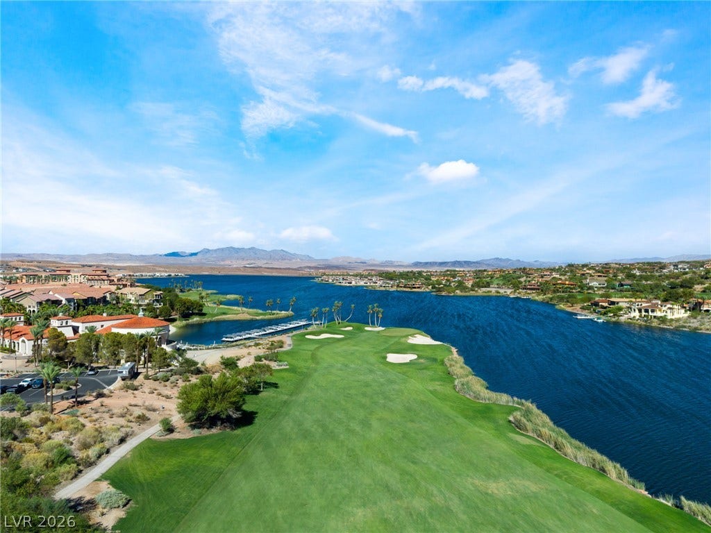 72 Rezzonico Drive, Henderson, NV 89011 Lush fairways border the deep blue lake waters under expansive desert skies.