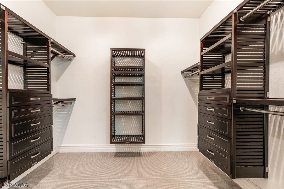 72 Rezzonico Drive, Henderson, NV 89011 Custom built-in shelving and ample drawer storage maximize organization in this generous walk-in closet.