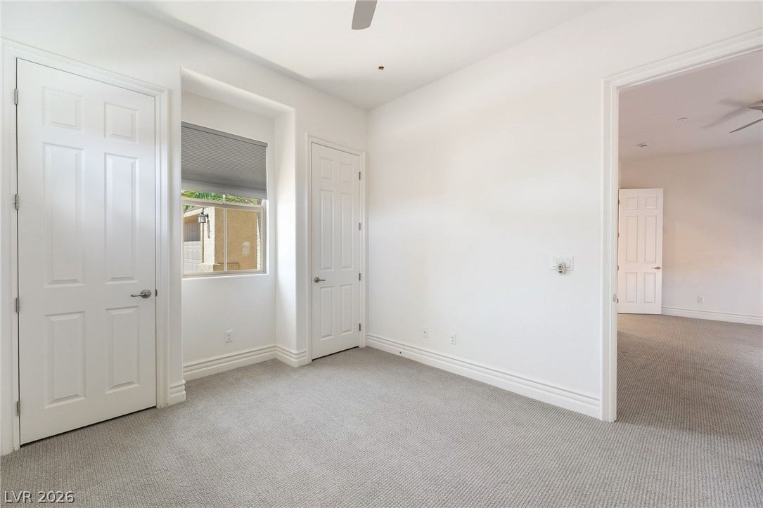72 Rezzonico Drive, Henderson, NV 89011 Smooth plaster walls and neutral carpeting define this quiet secondary bedroom.