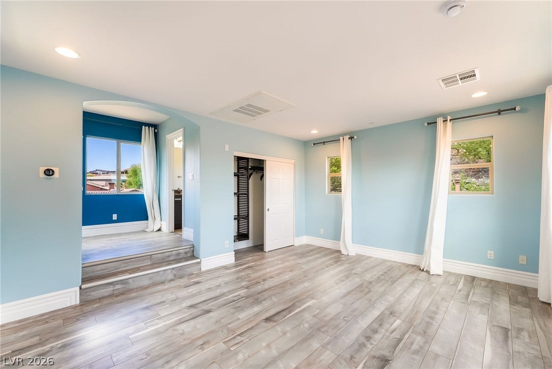 72 Rezzonico Drive, Henderson, NV 89011 Gleaming wood-look floors complement the light-filled design and unique multi-level layout of this versatile space.