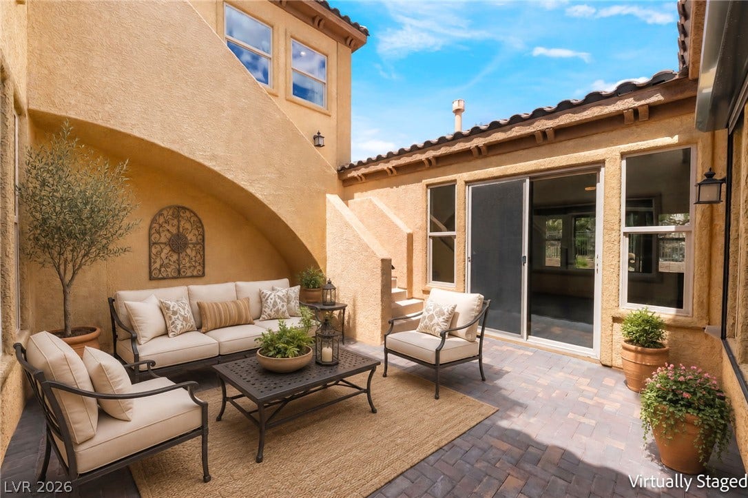 72 Rezzonico Drive, Henderson, NV 89011 Virtually Staged. An inviting stone-paved courtyard is nestled beneath Spanish tile roofs and textured stucco arches.